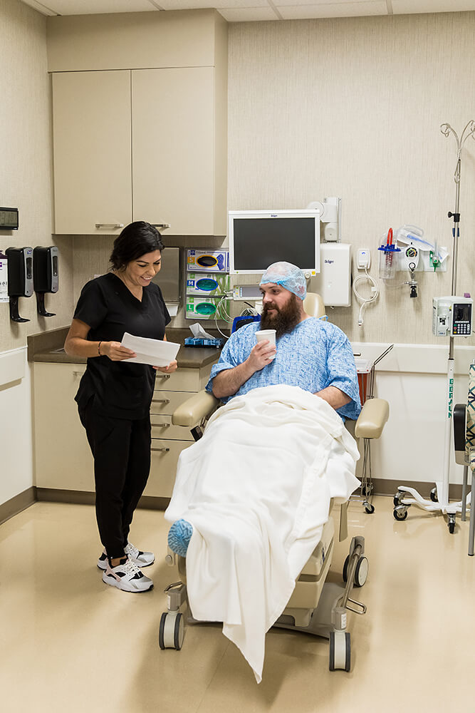 Photo of Patient and Nurse in a Hospital Room